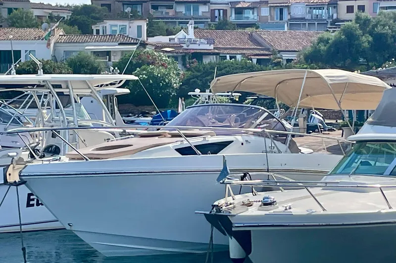  Yacht Photos Pics 2012 Cranchi Endurance 30 yacht docked in a marina, surrounded by other boats.