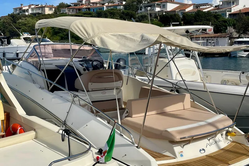  Yacht Photos Pics 2012 Cranchi Endurance 30 boat docked in a marina with canopy and seating.