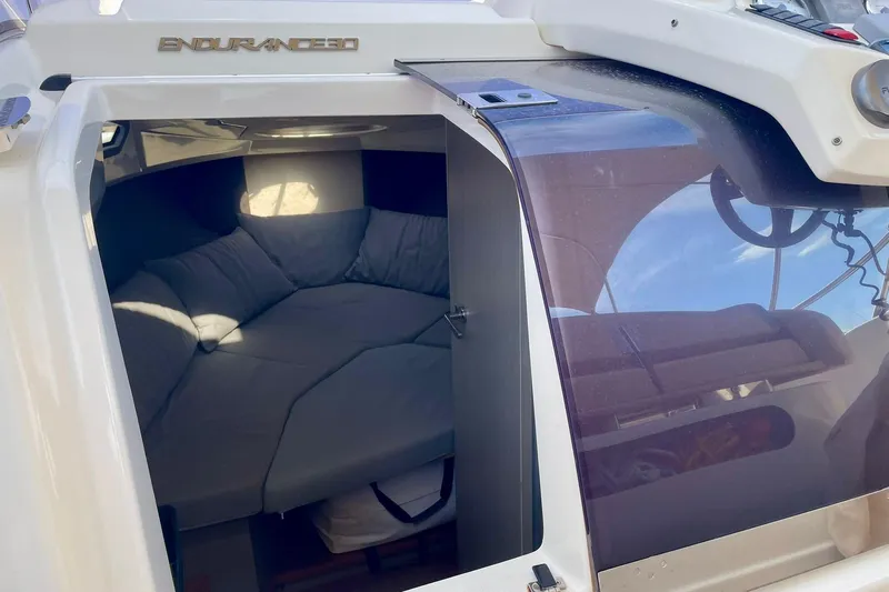  Yacht Photos Pics Cozy cabin interior of 2012 Cranchi Endurance 30 boat, featuring comfortable seating.