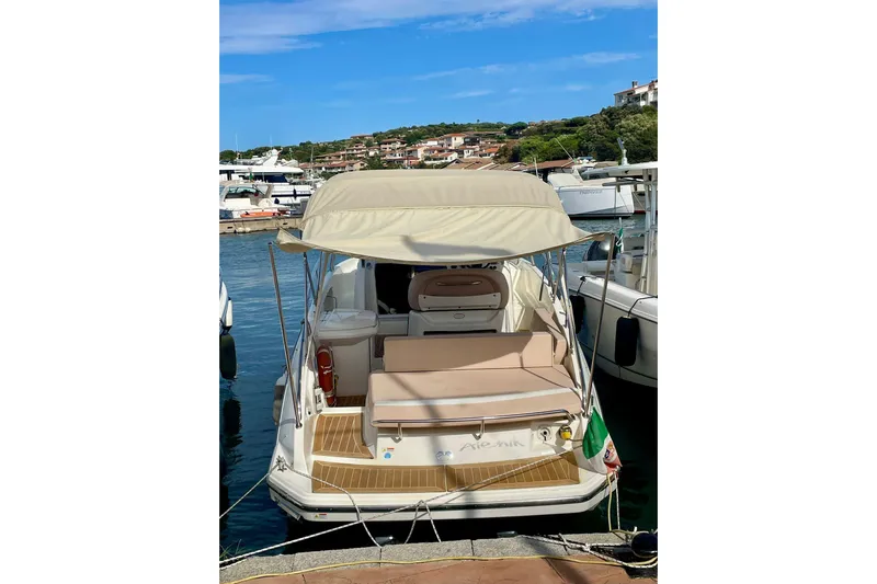  Yacht Photos Pics 2012 Cranchi Endurance 30 yacht docked at marina, featuring beige canopy and seating.