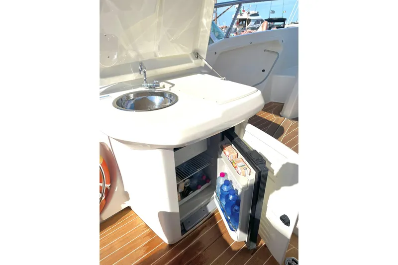 Yacht Photos Pics 2012 Cranchi Endurance 30 yacht kitchenette with sink and open mini fridge.