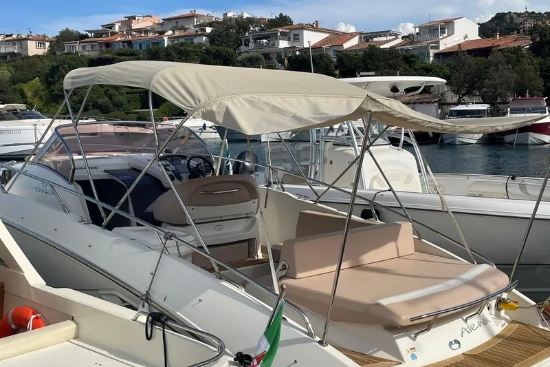  Yacht Photos Pics 2012 Cranchi Endurance 30 boat docked in a marina with canopy and seating.