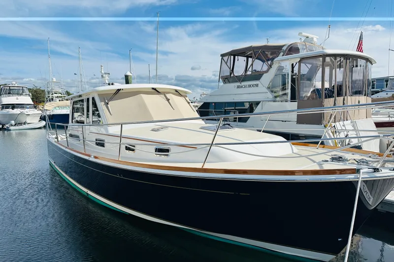 Encore Yacht Photos Pics 2017 Sabre 42 Salon Express yacht docked in marina under blue sky.