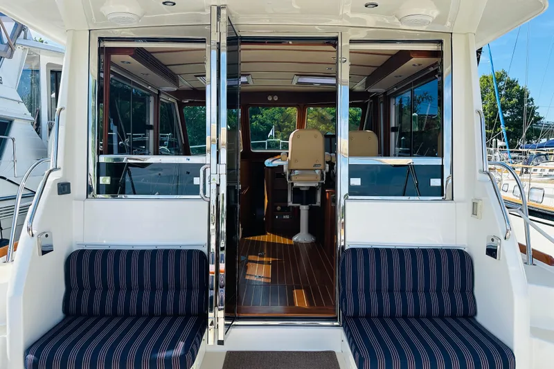 Encore Yacht Photos Pics 2017 Sabre 42 Salon Express yacht interior with striped seating and polished wood flooring.