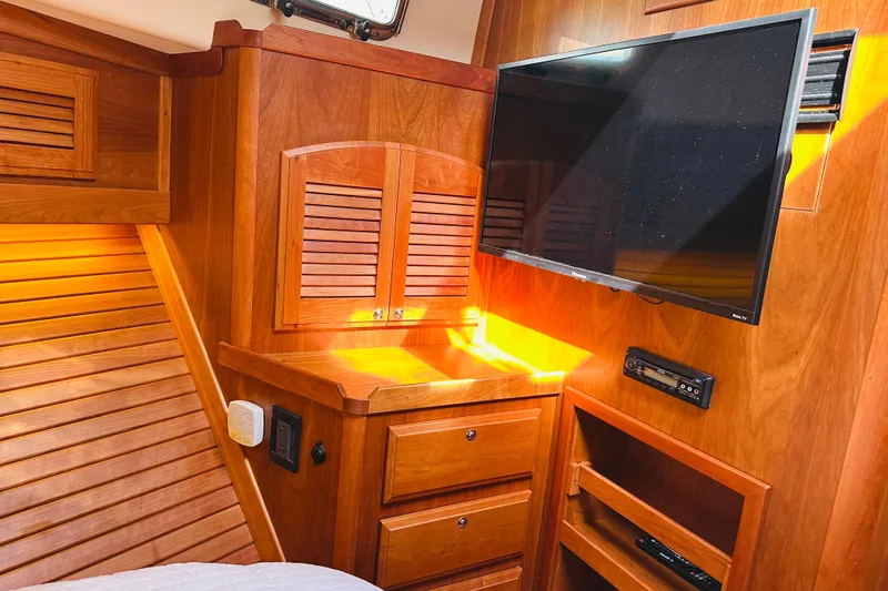 Encore Yacht Photos Pics Interior of 2017 Sabre 42 Salon Express with wood cabinetry and mounted TV.