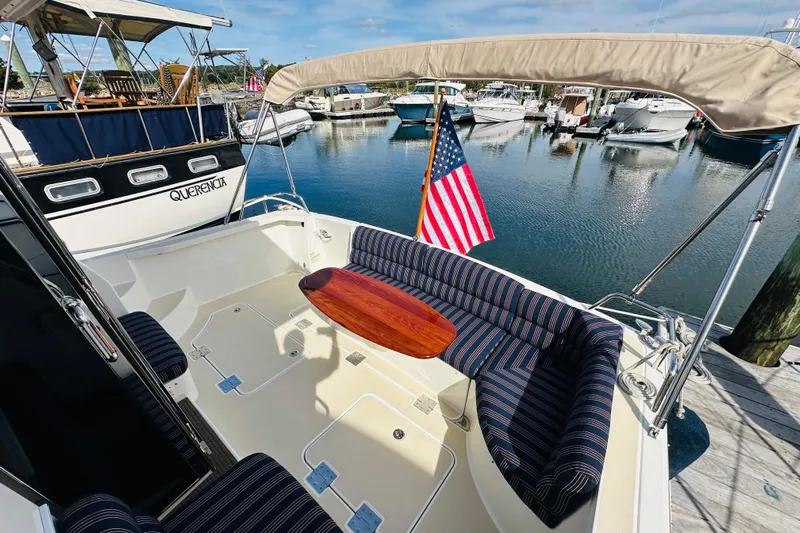 Encore Yacht Photos Pics 2017 Sabre 42 Salon Express yacht with striped seating and American flag in marina.