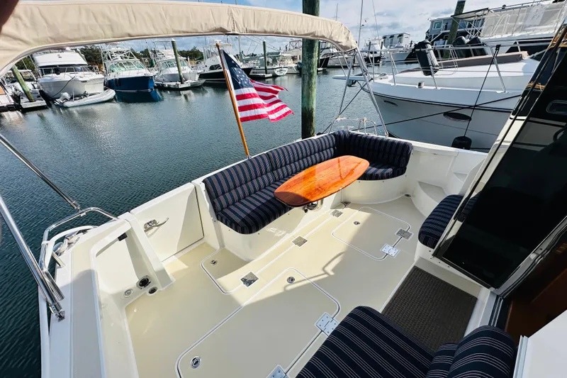 Encore Yacht Photos Pics 2017 Sabre 42 Salon Express yacht with seating area and American flag at marina.