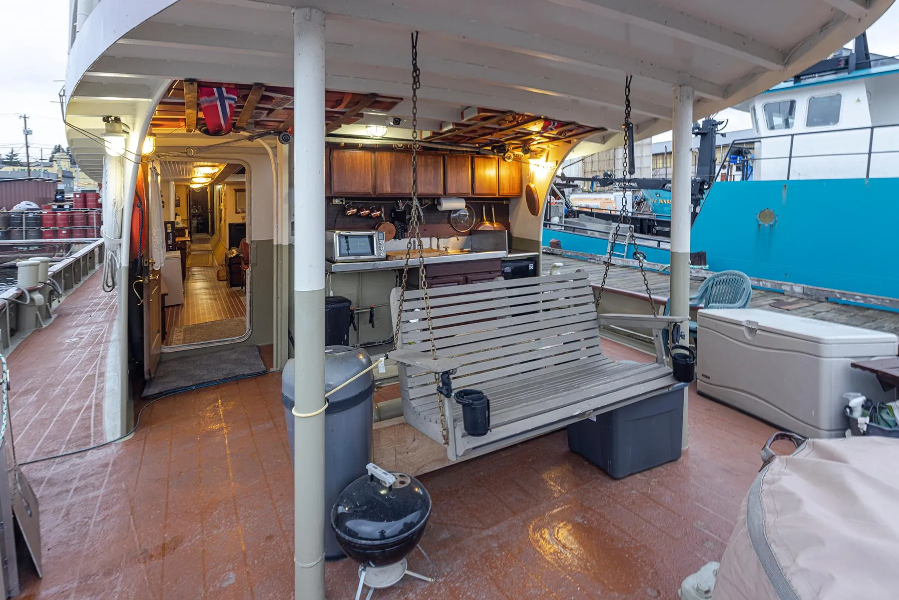1943 Custom Navy Tug with outdoor seating and grill on deck.
