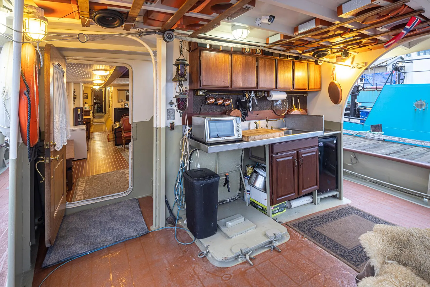 Interior of a 1943 Custom Navy Tug with kitchen and cozy living area.