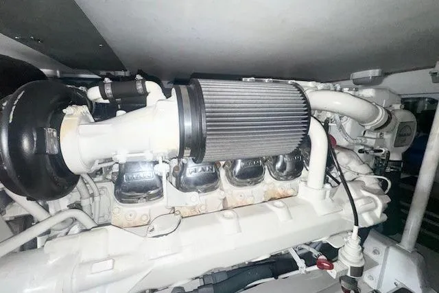 Slab Daddy Yacht Photos Pics Engine compartment of a 2000 Viking 50 Convertible yacht, showcasing detailed components.