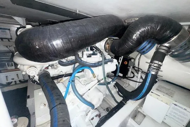 Slab Daddy Yacht Photos Pics Engine room of 2000 Viking 50 Convertible yacht with visible hoses and components.