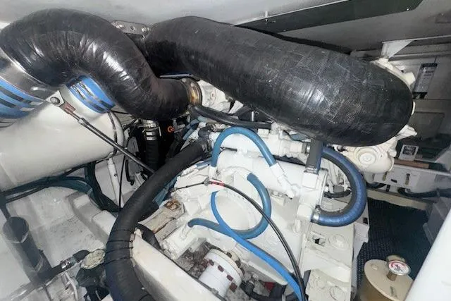 Slab Daddy Yacht Photos Pics Engine room of a 2000 Viking 50 Convertible yacht, showcasing complex machinery and hoses.