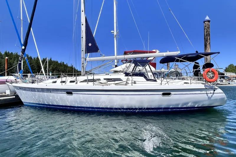  Yacht Photos Pics 2002 Catalina 390 sailboat docked in a marina under clear blue skies.