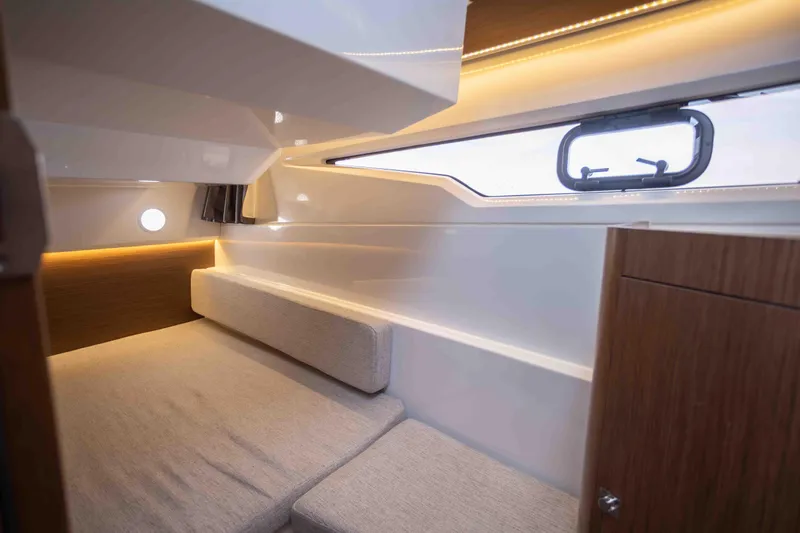  Yacht Photos Pics Interior cabin of 2022 Jeanneau NC Weekender 895, featuring cozy seating and modern design.