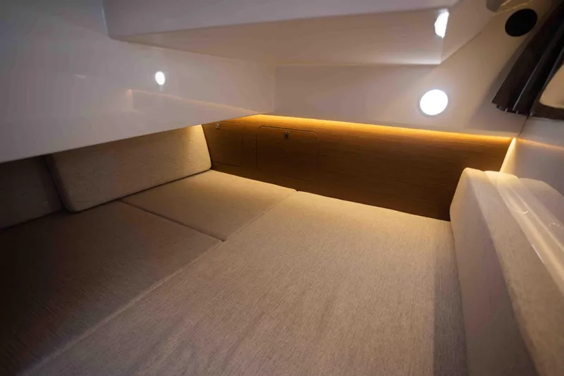  Yacht Photos Pics Interior cabin of 2022 Jeanneau NC Weekender 895 with cozy lighting and comfortable seating.