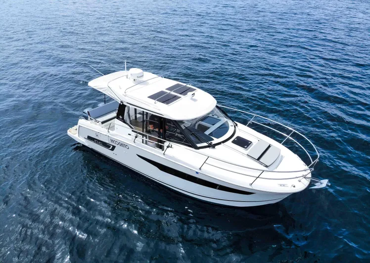  Yacht Photos Pics 2022 Jeanneau NC Weekender 895 cruising on open water, showcasing sleek design and modern features.