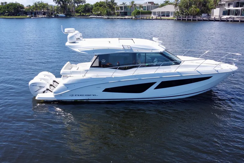 Carchi Yacht Photos Pics 2022 Regal 42 XO yacht on calm water, showcasing sleek design and powerful engines.