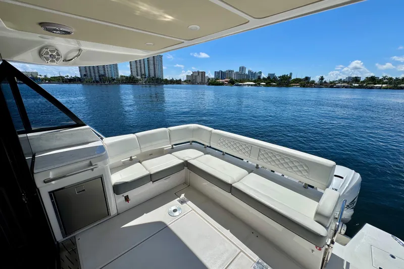 Carchi Yacht Photos Pics Luxury seating area on 2022 Regal 42 XO yacht with waterfront city view.