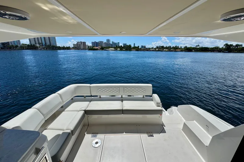 Carchi Yacht Photos Pics Luxury seating area on 2022 Regal 42 XO yacht overlooking serene waterfront.