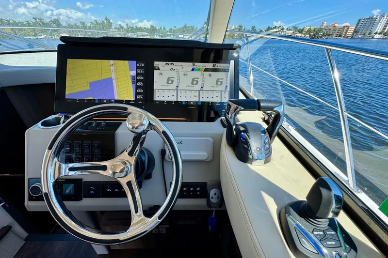 Carchi Yacht Photos Pics Cockpit of 2022 Regal 42 XO yacht with navigation screens and steering wheel.