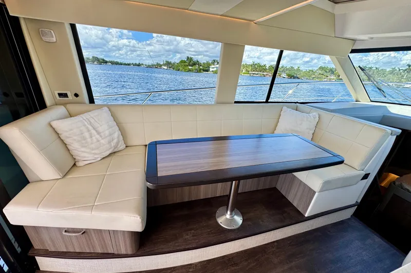 Carchi Yacht Photos Pics Luxurious interior of 2022 Regal 42 XO yacht with elegant seating and scenic water view.