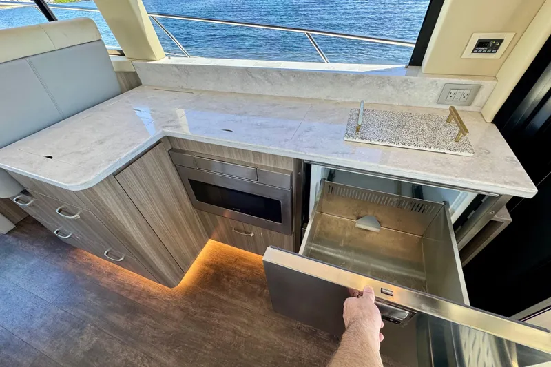 Carchi Yacht Photos Pics Luxurious 2022 Regal 42 XO yacht kitchen with modern appliances and ocean view.