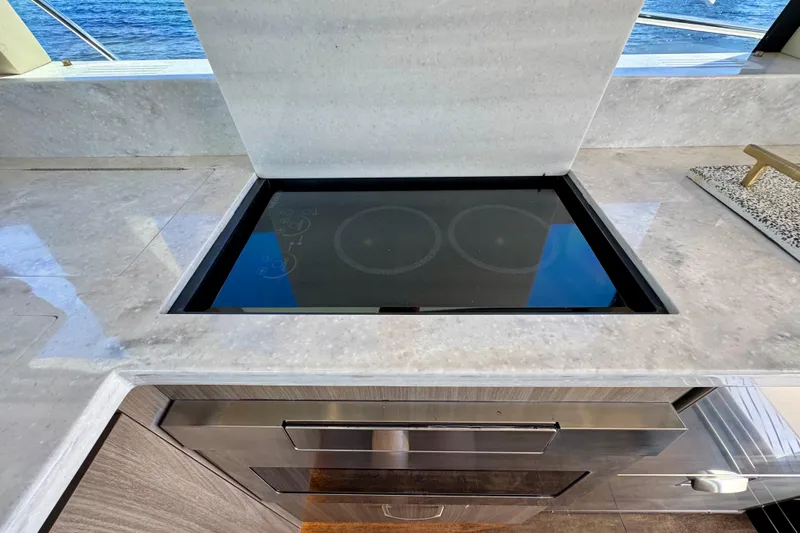 Carchi Yacht Photos Pics Modern kitchen on 2022 Regal 42 XO yacht with sleek induction cooktop.