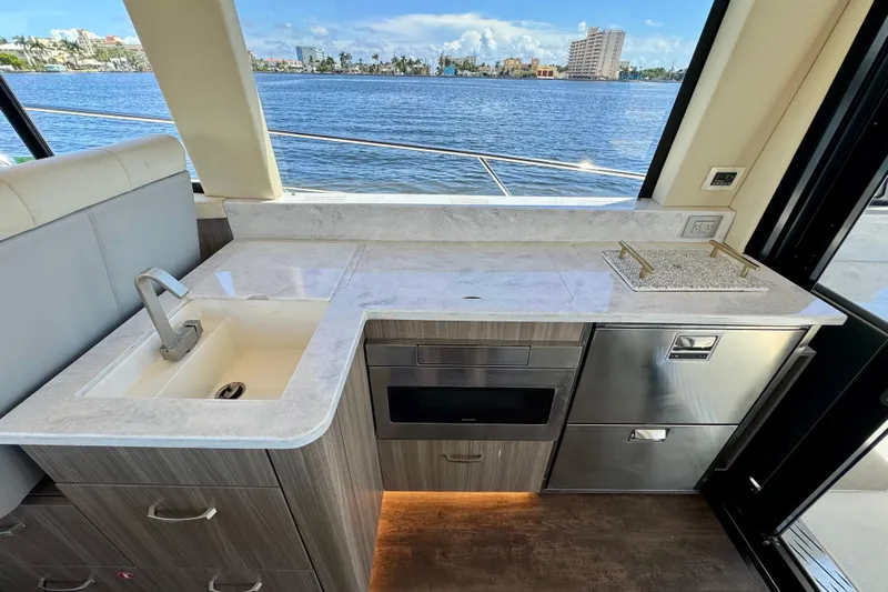Carchi Yacht Photos Pics Luxurious 2022 Regal 42 XO yacht kitchen with modern appliances and stunning waterfront view.