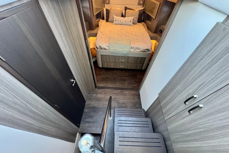 Carchi Yacht Photos Pics Luxurious interior of 2022 Regal 42 XO yacht with cozy bedroom and modern design.