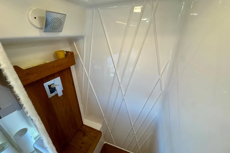 Carchi Yacht Photos Pics 2022 Regal 42 XO yacht interior with modern shower design and wooden accents.