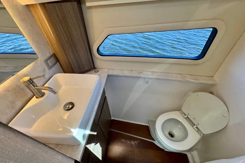 Carchi Yacht Photos Pics Luxurious bathroom in 2022 Regal 42 XO yacht with ocean view window.