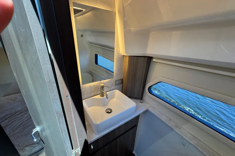 Carchi Yacht Photos Pics Luxurious bathroom interior of 2022 Regal 42 XO yacht with modern sink and window view.
