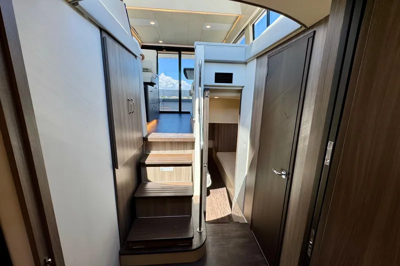 Carchi Yacht Photos Pics Interior view of 2022 Regal 42 XO yacht, featuring modern wood finishes and natural lighting.