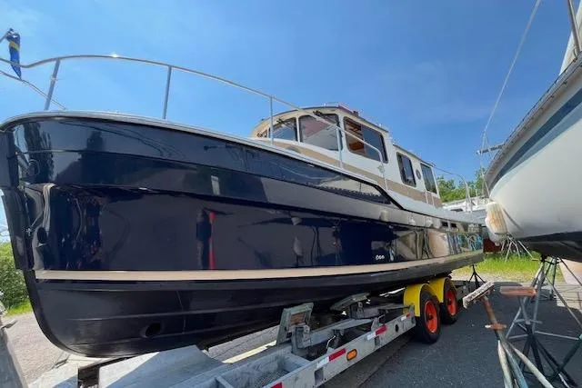 Mystic Yacht Photos Pics 2014 Ranger Tugs R-31 boat on trailer under clear blue sky.