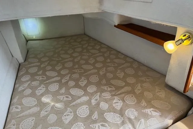 Mystic Yacht Photos Pics Cozy cabin bed in 2014 Ranger Tugs R-31 with patterned bedding and soft lighting.