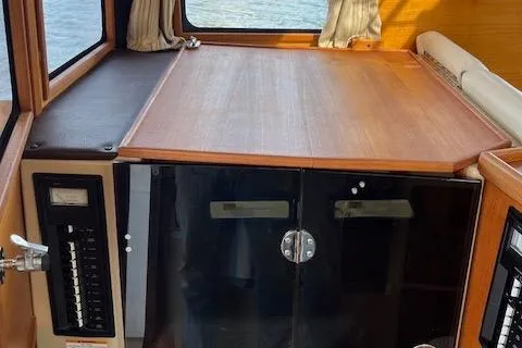 Mystic Yacht Photos Pics 2014 Ranger Tugs R-31 interior with wooden cabinetry and control panel.