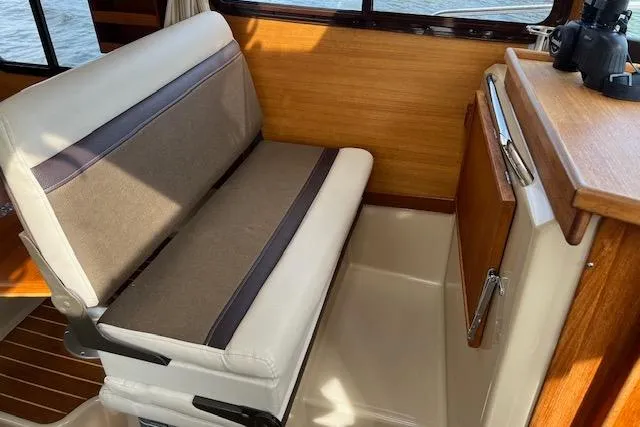 Mystic Yacht Photos Pics Interior seating of 2014 Ranger Tugs R-31 boat with wooden accents.