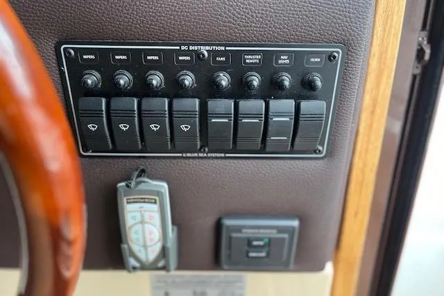 Mystic Yacht Photos Pics Control panel of a 2014 Ranger Tugs R-31 boat with labeled switches and remote.