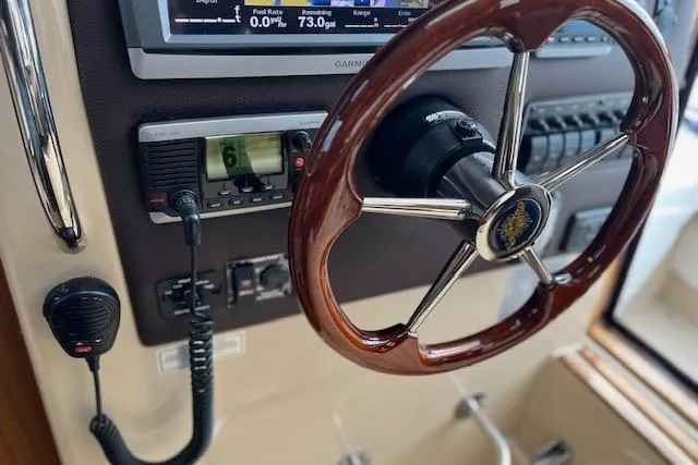 Mystic Yacht Photos Pics Steering wheel and controls of a 2014 Ranger Tugs R-31 boat cockpit.