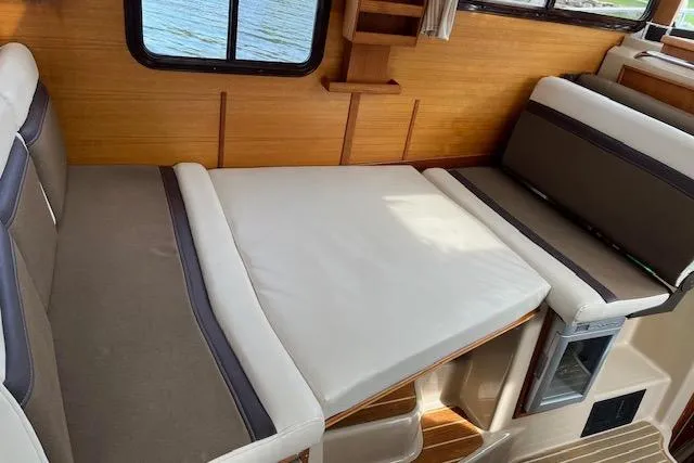 Mystic Yacht Photos Pics 2014 Ranger Tugs R-31 interior with convertible seating and wooden accents.