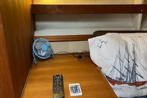 Mystic Yacht Photos Pics Cozy cabin interior of 2014 Ranger Tugs R-31 with fan, remote, and nautical bedding.