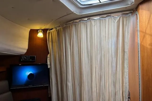 Mystic Yacht Photos Pics Interior of 2014 Ranger Tugs R-31 with curtain, TV, and ceiling light.