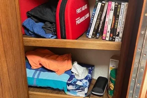 Mystic Yacht Photos Pics Storage shelves on a 2014 Ranger Tugs R-31 with first aid kit and DVDs.