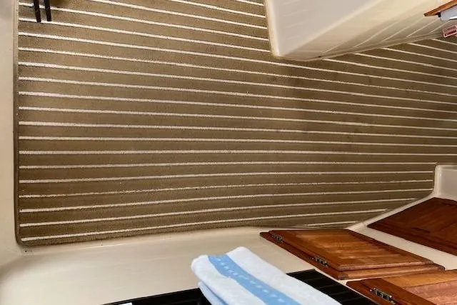 Mystic Yacht Photos Pics 2014 Ranger Tugs R-31 interior with striped flooring and wooden accents.