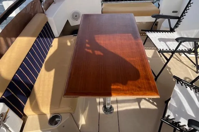 Mystic Yacht Photos Pics 2014 Ranger Tugs R-31 boat interior with wooden table and cushioned seating.