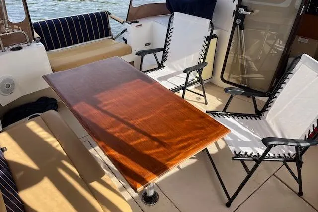 Mystic Yacht Photos Pics 2014 Ranger Tugs R-31 boat interior with table, chairs, and seating area.