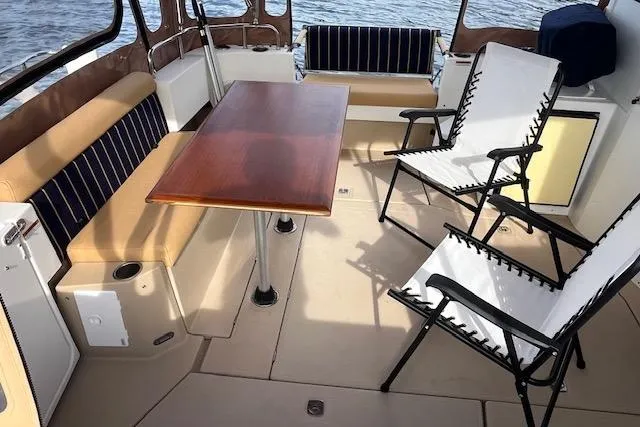 Mystic Yacht Photos Pics 2014 Ranger Tugs R-31 boat interior with seating, table, and chairs on deck.