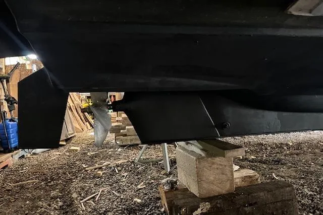 Mystic Yacht Photos Pics 2014 Ranger Tugs R-31 boat hull and propeller on wooden supports in a workshop.