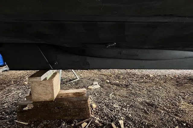 Mystic Yacht Photos Pics 2014 Ranger Tugs R-31 boat hull on wooden blocks, gravel ground.