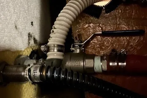 Mystic Yacht Photos Pics Plumbing components in a 2014 Ranger Tugs R-31 boat, featuring hoses and a valve.